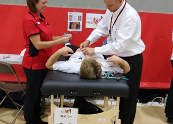 Bill and Kelli perform an EKG at YH4L screening